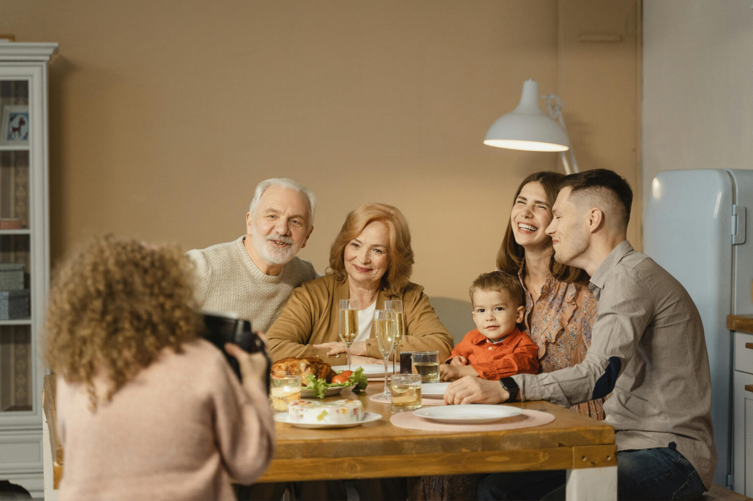 Multi-generational family laughing together at the dinner table