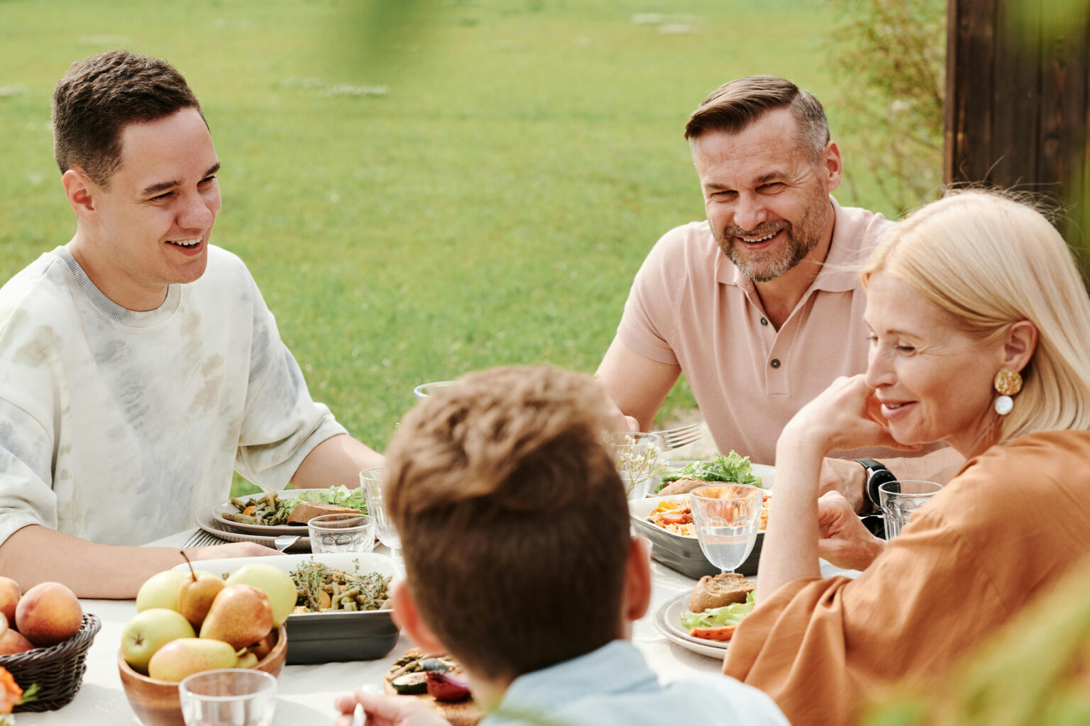 Hearing aids wellness: family enjoying a healthy meal outdoors